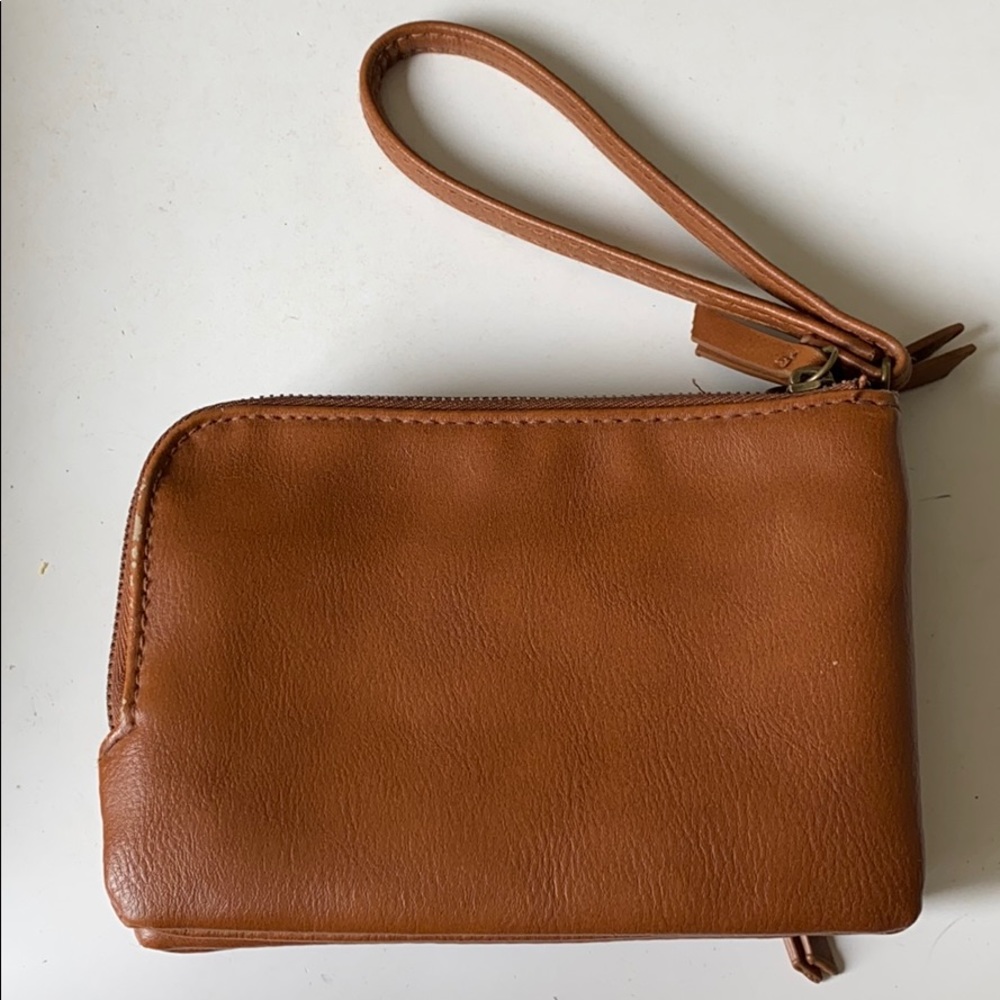 Brown clutch wallet with detachable strap.